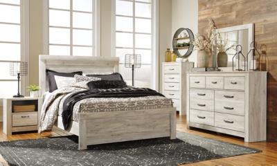 Ashley Furniture Bellaby Bed with a sleek wooden frame and neutral upholstery, shown in a modern bedroom setting.