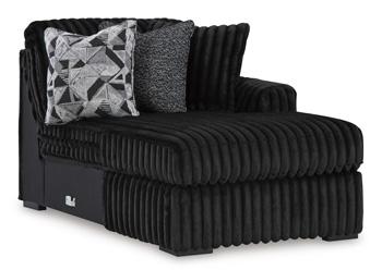 Ashley Furniture Midnight-Madness sectional sofa with chaise, featuring plush cushions and modern design in a stylish living room setting.