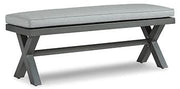 Outdoor dining bench by Ashley Furniture with cushion, designed for outdoor seating and patio use.