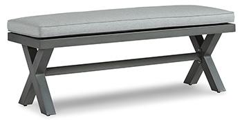 Outdoor dining bench by Ashley Furniture with cushion, designed for outdoor seating and patio use.