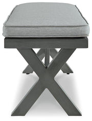 Outdoor dining bench with cushion from Ashley Furniture, featuring a sturdy wooden frame and comfortable seating for outdoor spaces.