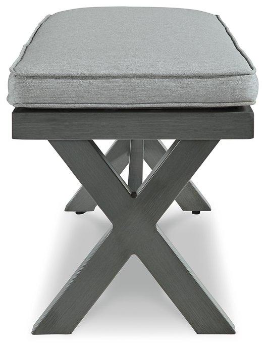 Outdoor dining bench with cushion from Ashley Furniture, featuring a sturdy wooden frame and comfortable seating for outdoor spaces.