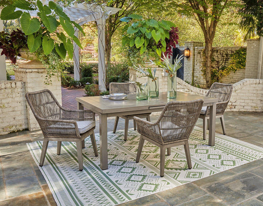 Outdoor dining set by Ashley Furniture with a table and chairs on a beach front patio, ideal for outdoor gatherings.