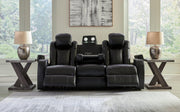 Ashley Furniture Caveman Den Power Reclining Sofa, plush fabric, adjustable reclining seats, modern design, shown in a living room setting.