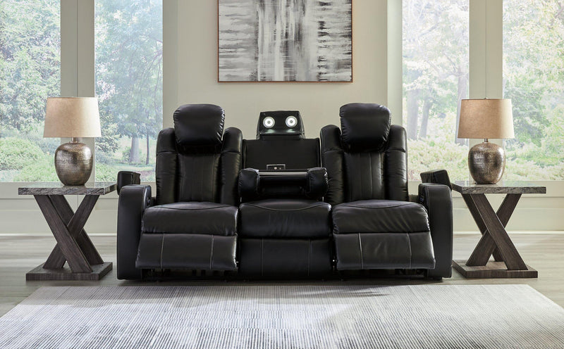 Ashley Furniture Caveman Den Power Reclining Sofa, plush fabric, adjustable reclining seats, modern design, shown in a living room setting.