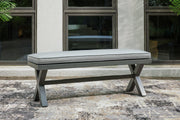 Outdoor dining bench by Ashley Furniture with a cushioned seat, suitable for patio or garden seating.