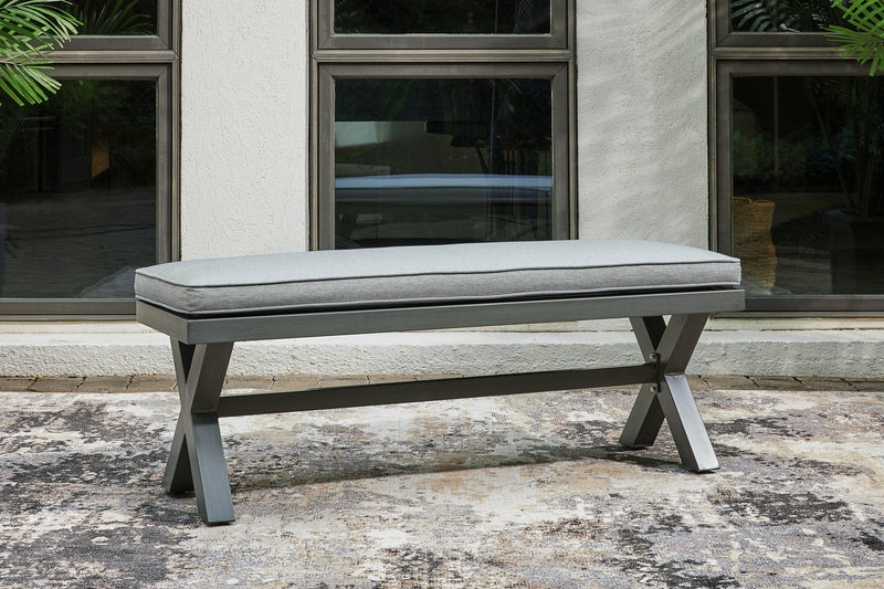 Outdoor dining bench by Ashley Furniture with a cushioned seat, suitable for patio or garden seating.