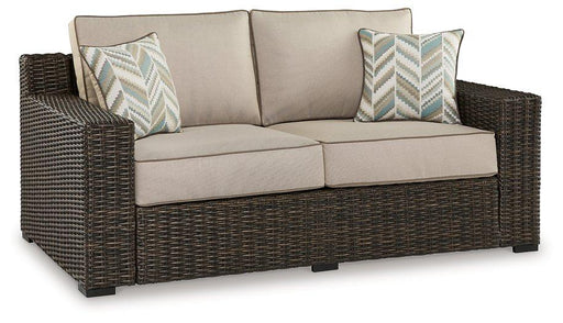 Outdoor loveseat with cushion by Ashley Furniture, Coastline Bay style, featuring comfortable seating and weather-resistant design.