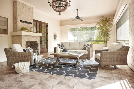 Ashley Furniture Beachcroft outdoor conversation set with cushioned seats and a coffee table, ideal for patio relaxation