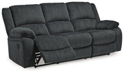 Ashley Furniture Draycoll reclining sofa with plush cushions and modern design, shown in a cozy living room setting.