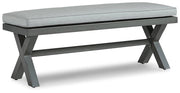 Outdoor dining bench by Ashley Furniture with cushioned seat, ideal for garden or patio seating.