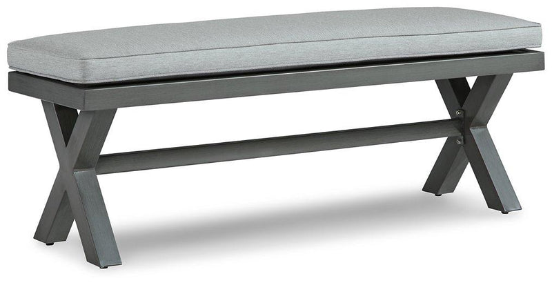 Outdoor dining bench by Ashley Furniture with cushioned seat, ideal for garden or patio seating.