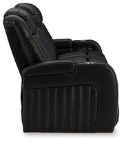 Ashley Furniture Caveman Den Power Reclining Sofa with plush cushions and reclining seats, ideal for comfortable living room seating.
