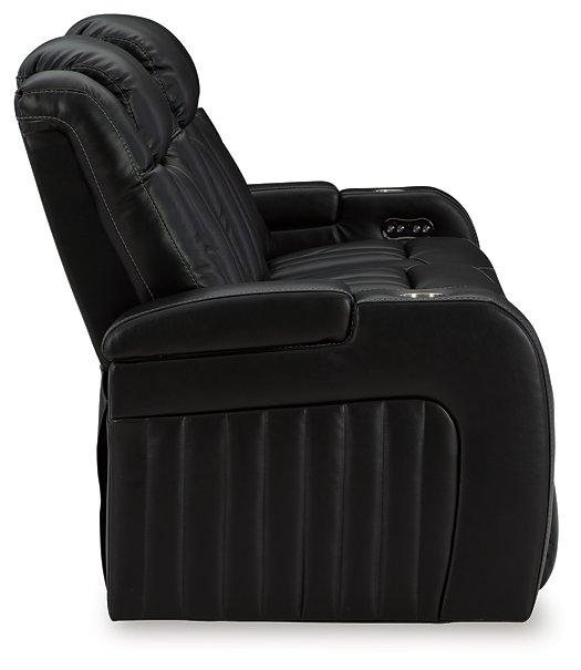 Ashley Furniture Caveman Den Power Reclining Sofa with plush cushions and reclining seats, ideal for comfortable living room seating.