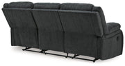 Ashley Furniture Draycoll reclining sofa with plush cushions and reclining features, shown in a modern living room setting.