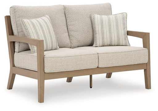 Ashley Furniture Hallow Creek outdoor loveseat with cushion, featuring a sturdy frame and comfortable seating for outdoor relaxation.