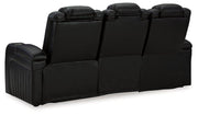 Ashley Furniture Caveman Den Power Reclining Sofa showing plush fabric, padded armrests, and reclining features in a modern living room setting.