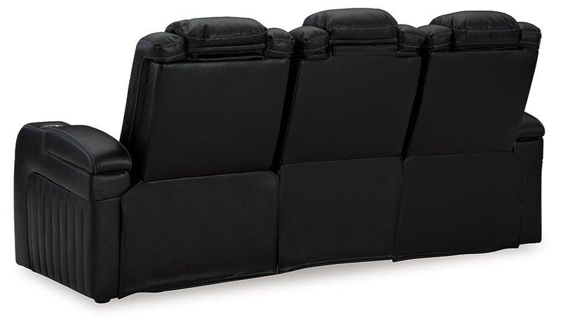 Ashley Furniture Caveman Den Power Reclining Sofa showing plush fabric, padded armrests, and reclining features in a modern living room setting.