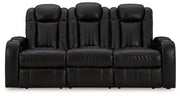 Ashley Furniture Caveman Den Power Reclining Sofa with plush cushions and reclining feature, shown in a modern living room setting.