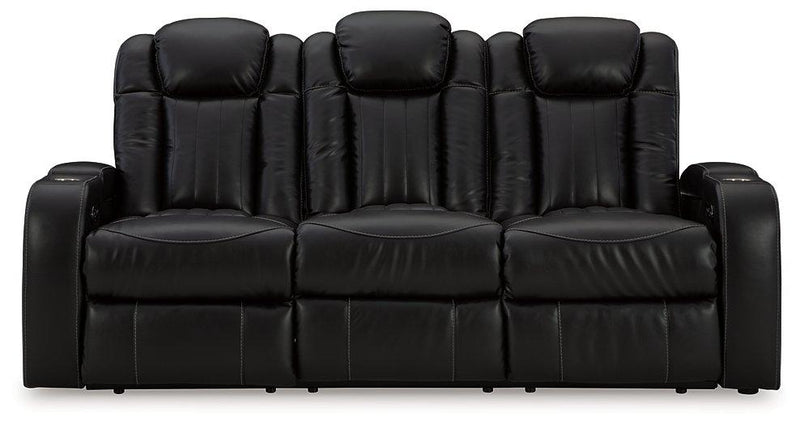 Ashley Furniture Caveman Den Power Reclining Sofa with plush cushions and reclining feature, shown in a modern living room setting.