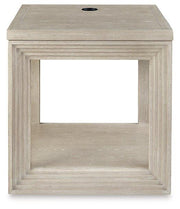 Ashley Furniture Marxhart End Table with wood finish and modern design, featuring a sturdy top and stylish base.
