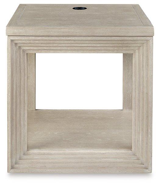 Ashley Furniture Marxhart End Table with wood finish and modern design, featuring a sturdy top and stylish base.
