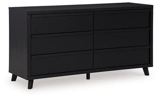 Modern Ashley Furniture Danziar Dresser with sleek wood finish and multiple storage drawers on a neutral background.