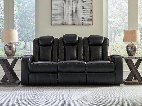 Ashley Furniture Caveman Den power reclining sofa with plush cushions and reclining features, shown in a modern living room setting.