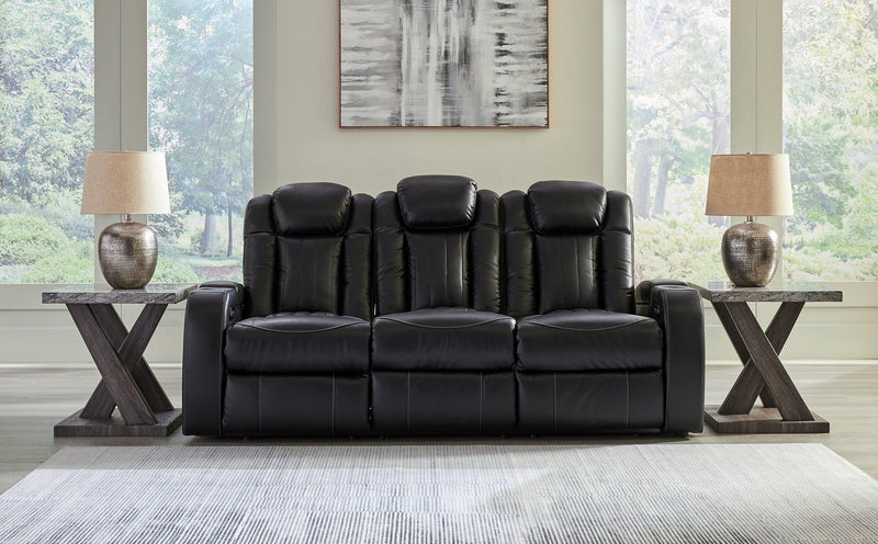 Ashley Furniture Caveman Den Power Reclining Sofa, plush fabric, padded armrests, and reclining features for comfortable seating.