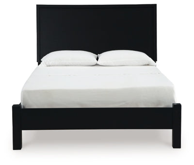 Ashley Furniture Danziar Bed with a wooden headboard and frame, shown from a front-on angle in a bedroom setting.