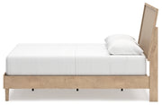 Ashley Furniture Cielden Bed with a wooden frame and neutral finish, shown from a side view in a modern bedroom setting.