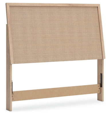 Ashley Furniture Cielden bed with a stylish wooden frame, shown from an angled side view in a modern bedroom setting.