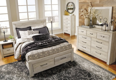 Ashley Furniture Bellaby Bed with plush upholstered headboard and sleek wooden frame, modern bedroom furniture piece.