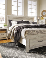 Ashley Furniture Bellaby Bed in a modern design with a sturdy frame and neutral finish, shown in a bedroom setting.