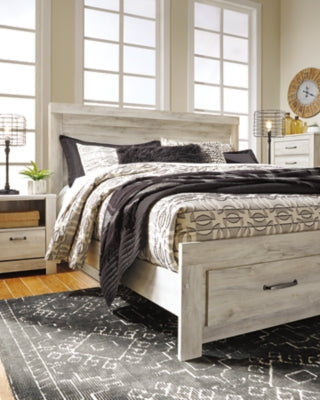 Ashley Furniture Bellaby Bed in a modern design with a sturdy frame and neutral finish, shown in a bedroom setting.