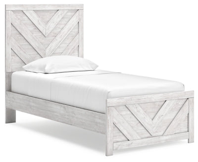 Ashley Furniture Cayboni Bed with elegant wooden frame and angled headboard, shown from a side angle.