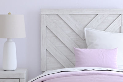 Close-up of Ashley Furniture Cayboni Bed showing its detailed headboard design and rich wood finish.