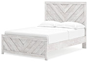 Ashley Furniture Cayboni Bed with a sleek, modern frame and neutral upholstery, shown from an angled side view.