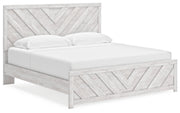 Ashley Furniture Cayboni Bed with a modern design, shown from an angled side view, featuring a sleek wooden frame and headboard.