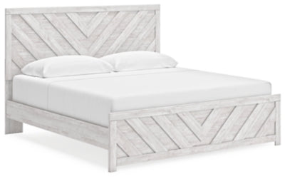 Ashley Furniture Cayboni Bed with a modern design, shown from an angled side view, featuring a sleek wooden frame and headboard.