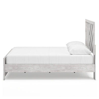 Ashley Furniture Cayboni Bed with a wooden frame and detailed headboard, shown from the side in natural wood finish.