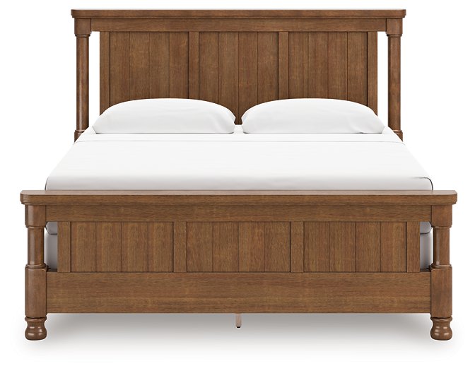 Ashley Furniture Chadworth Bed with a headboard featuring a classic design and rich wood finish.
