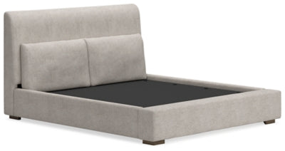 Ashley Furniture Cabalynn upholstered bed with a plush headboard and elegant design, shown from an angled perspective.