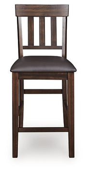 Ashley Furniture Haddigan counter height bar stool with wooden legs and upholstered seat, shown from a front head-on view.