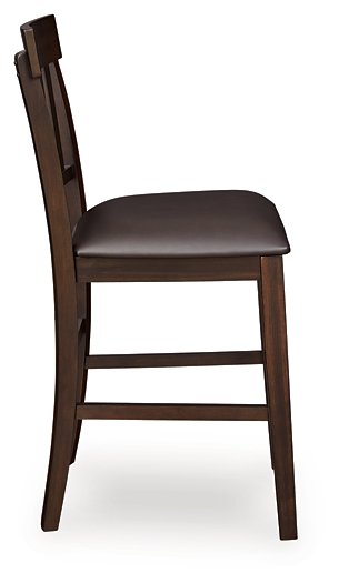 Ashley Furniture Haddigan counter height bar stool with wooden legs and upholstered seat, viewed from the side.