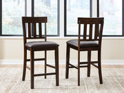 Ashley Furniture Haddigan counter height bar stool with wooden legs and upholstered seat, shown from a front view.