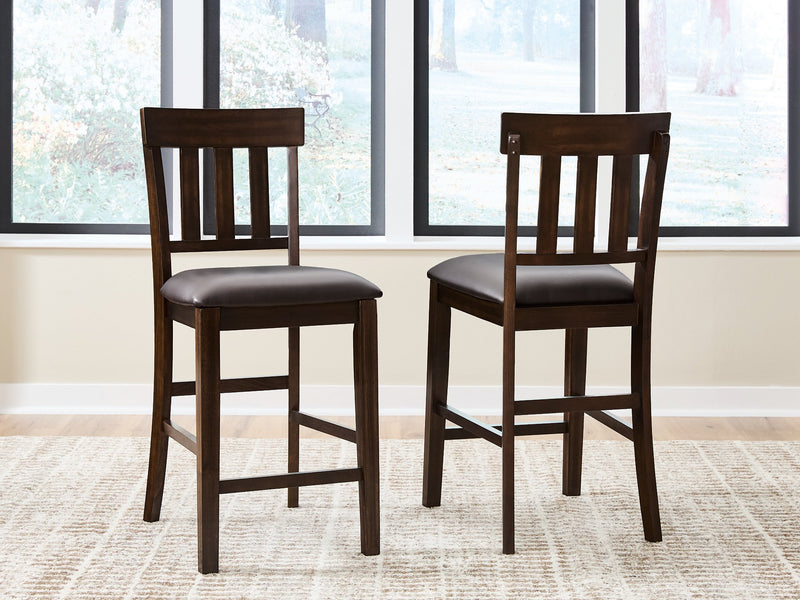 Ashley Furniture Haddigan counter height bar stool with wooden legs and upholstered seat, shown from a front view.