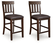 Ashley Furniture Haddigan counter height bar stool with wooden frame and cushioned seat, shown from an angled side view.