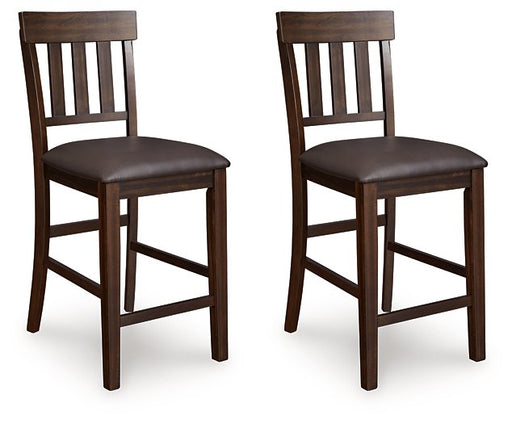 Ashley Furniture Haddigan counter height bar stool with wooden frame and cushioned seat, shown from an angled side view.