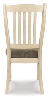 Ashley Furniture Bolanburg dining room set with a rectangular table and six upholstered chairs, seen from the back view.
